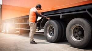 Auto mechanic checking a truck wheels tires truck inspection maintenance safety driving