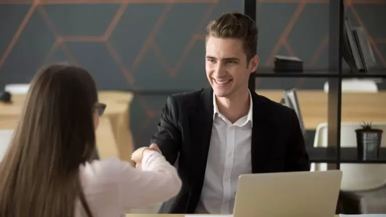 Smiling hr employer handshaking successful job applicant hiring or greeting Smiling hr employer handshaking successful job applicant hiring or greeting