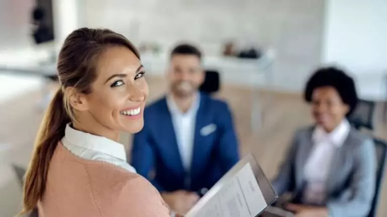 Young happy woman having an job interview in the office